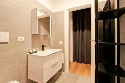 a bathroom with a white sink and a mirror at La Casa di Chantal in Rome