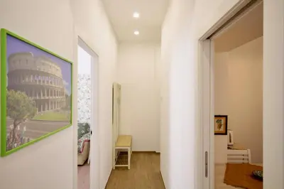 a hallway with a painting of the coliseum at HC - Piazza Vittorio Emanuele Dream in Rome