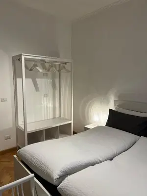 a bedroom with two beds and a glass cabinet at Cozy Donatello Apartment in Rome