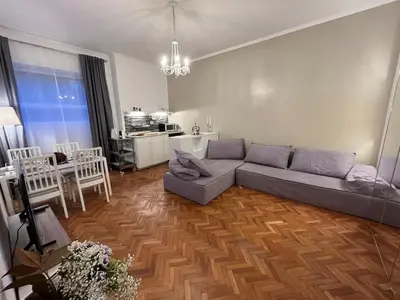 a living room with a couch and a table at Cozy Donatello Apartment in Rome