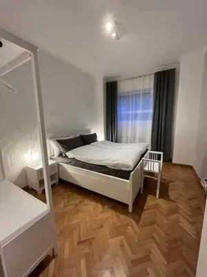 a bedroom with a white bed and a window at Cozy Donatello Apartment in Rome