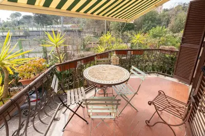 a patio with a table and chairs on a balcony at Domus Caroli in Vaticano in Rome