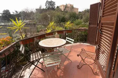 a patio with a table and chairs on a balcony at Domus Caroli in Vaticano in Rome