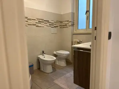 a bathroom with a toilet and a sink at Le Crete Apartment in Rome