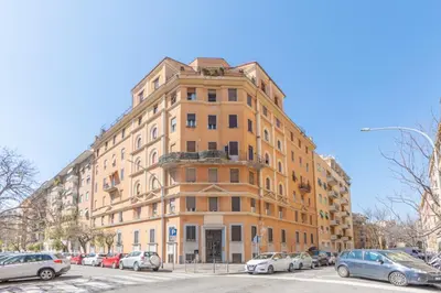 a tall building with cars parked in front of it at B&B Floret Roma San Giovanni in Rome