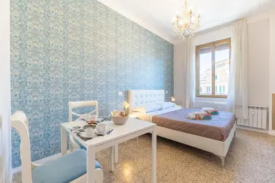 a bedroom with a bed and a table and a dining room at B&B Floret Roma San Giovanni in Rome