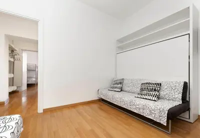 a white living room with a couch in a room at Irpini in Rome