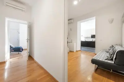 a living room with a couch and a room with a kitchen at Irpini in Rome
