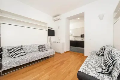 a living room with a couch and a white wall at Irpini in Rome