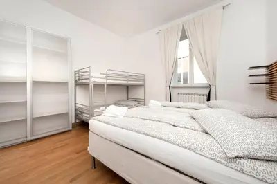 a white bedroom with two bunk beds and a window at Irpini in Rome