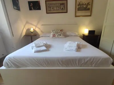 a bedroom with a white bed with towels on it at La Terrazza del Poeta in Rome