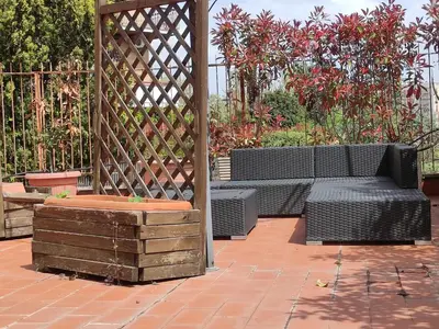 a gazebo with a bench and a wooden box at La Terrazza del Poeta in Rome