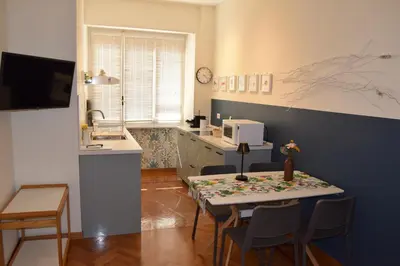 a kitchen with a table and chairs in a kitchen at Casa Luminosa in Monteverde in Rome