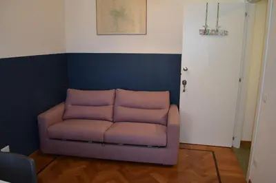 a purple couch in a room with a blue wall at Casa Luminosa in Monteverde in Rome