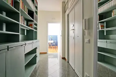 a hallway with green and white shelves and a door at Casa Luminosa in Monteverde in Rome