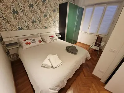 a bedroom with a white bed with towels on it at Casa Luminosa in Monteverde in Rome