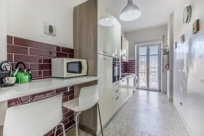 a kitchen with a white counter and a microwave at Iris Suite Colli Portuensi in Rome