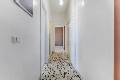 a hallway with a black and white patterned floor at Iris Suite Colli Portuensi in Rome