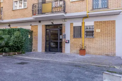 a brick building with a door and a courtyard at Iris Suite Colli Portuensi in Rome