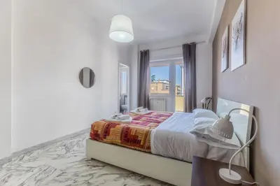 a bedroom with a bed and a window at Iris Suite Colli Portuensi in Rome