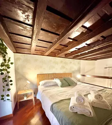 a bedroom with a bed with towels on it at Trastevere Loft garden in Rome