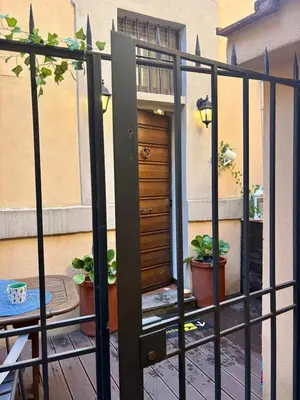 a room with a staircase and a table and chairs at Trastevere Loft garden in Rome