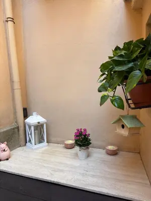 a staircase leading up to a dining room with a table at Trastevere Loft garden in Rome