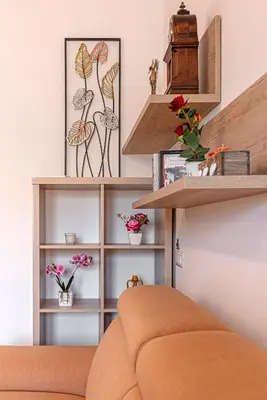 a living room with wooden shelves and a couch at San Giovanni Al Colosseo in Rome