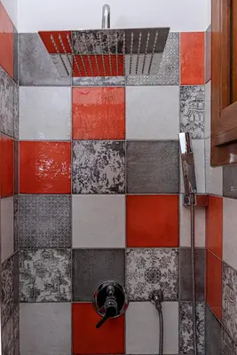 a tiled shower with a faucet in a bathroom at San Giovanni Al Colosseo in Rome