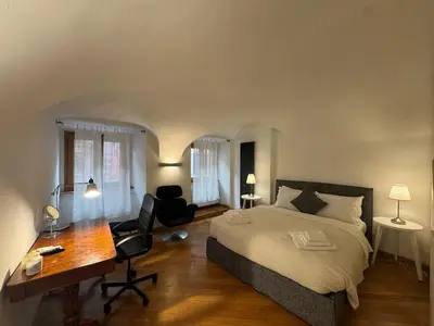 a bedroom with a bed and a desk and a chair at New! Renovated Apt in Ancient Rome in Rome