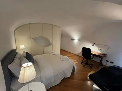 a bedroom with a bed and a desk and a chair at New! Renovated Apt in Ancient Rome in Rome