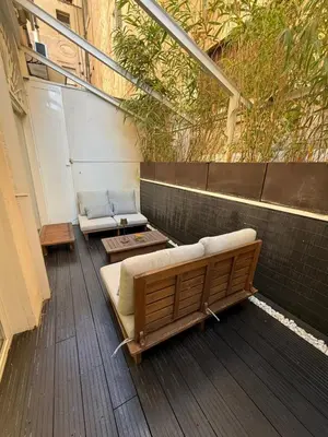 a balcony with a bench and a table on a building at loft Trastevere in Rome