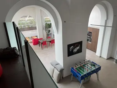a living room with a table in the middle of a room at loft Trastevere in Rome