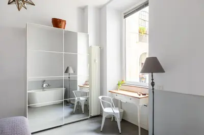 a white room with a desk and a sink at Trastevere Modern 4BR 4baths, WIFI, AC, custom kitchen, living room in Rome