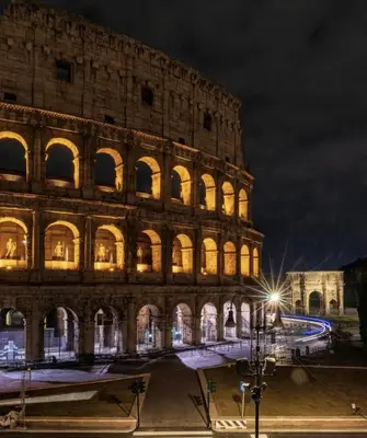 a view of the coliseum at night at Borghese Luxury Loft - LIBERTY COLLECTION in Rome