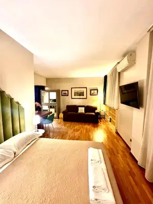 a living room with a bed and a couch at Borghese Luxury Loft - LIBERTY COLLECTION in Rome