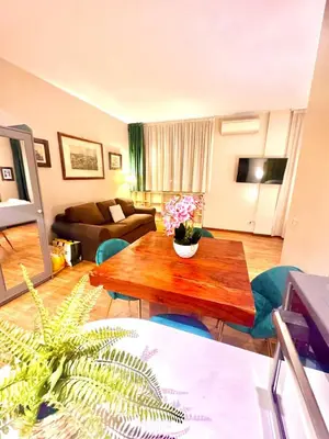 a living room with a table and a couch at Borghese Luxury Loft - LIBERTY COLLECTION in Rome