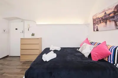 a bedroom with a bed with two towels on it at Casa Chicca Monti - Idromassaggio 900 m Colosseo in Rome