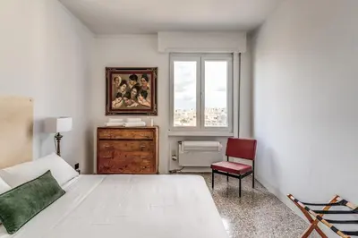 a bedroom with a white bed and a window at Amazing Piramide Metro Station in Rome