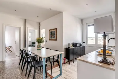 a kitchen and dining room with a table and chairs at Amazing Piramide Metro Station in Rome