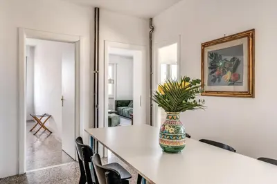 a dining room with a table with a vase on it at Amazing Piramide Metro Station in Rome