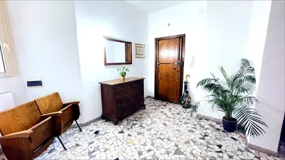 a room with a dresser and a door and a plant at Domus Remo Room #2 in Rome