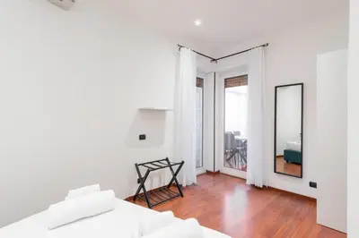 a white room with a bed and a mirror at Nōma Pigneto by Hostand in Rome