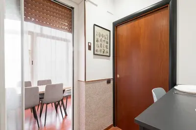 a dining room with a table and chairs at Nōma Pigneto by Hostand in Rome