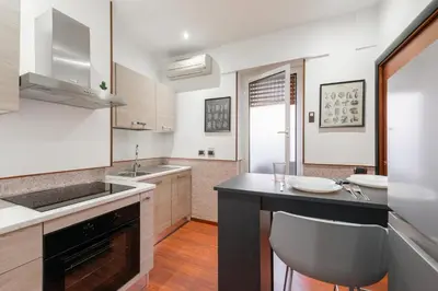 a kitchen with a sink and a counter top at Nōma Pigneto by Hostand in Rome