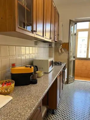 a kitchen with a counter top with a microwave at Casa del Grillo in Rome