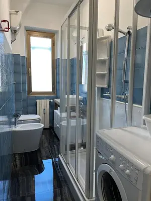 a bathroom with a washing machine and a sink at Casa del Grillo in Rome