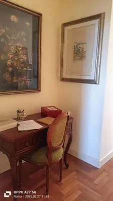 an office with a wooden desk with a chair and a picture at Terrace of the Aureli in Rome
