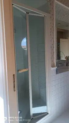 a shower with a glass door in a bathroom at Terrace of the Aureli in Rome