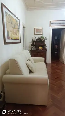 a living room with a couch and a table at Terrace of the Aureli in Rome